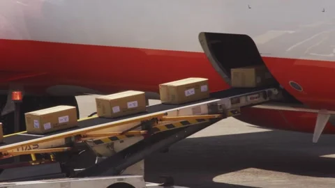 Belt loader loading cargo boxes into airplane hold, Taiwan, 2026.09.09. Stock Footage 345425346