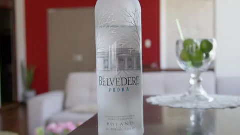 Belvedere vodka bottle on a bar table with lemons in a luxury living room Stock Footage 306005772