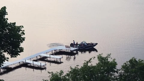 BEMIDJI, MN - 2 JUN 2023: Family in fishing boat leaves the dock. Stock Footage 251756881