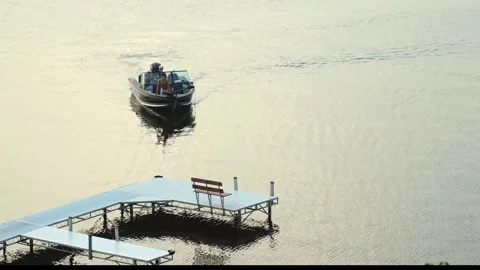 BEMIDJI, MN - 2 JUN 2023: Family in fishing boat slowly approach dock. Stock Footage 251756883