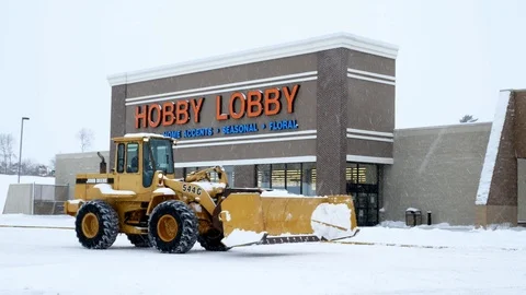 BEMIDJI, MN - 27 DEC 2018: Snow plow in front of entrance to Hobby Lobby store. Stock Footage 101898157