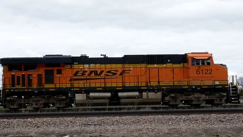 BEMIDJI, MN - 5 MAY 2019: Locomotive train engine and two older gray cars. Stock Footage 112583389