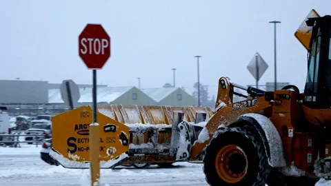 BEMIDJI, MN - DEC 27, 2018: Yellow front end loader is a snow removal machine. Stock Footage 104726833