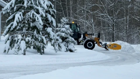 BEMIDJI, MN - DEC 28, 2018: Snow removal machine clearing snow on street. Stock Footage 100559774