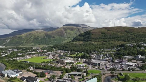 Ben Nevis behind clouds and Fort William aerial view drone pull back Video stock 295853062