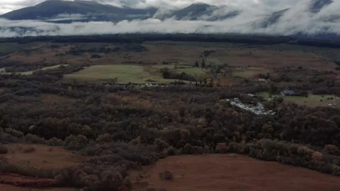 Ben Nevis mountain range surrounded by clouds at sunrise - aerial footage 4k Stock Footage 167784552