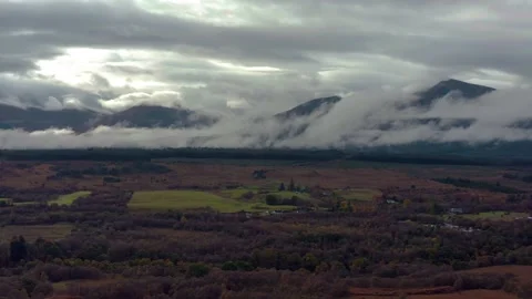Ben Nevis mountain range surrounded by clouds at sunrise - aerial footage 4k Stock Footage 167784560