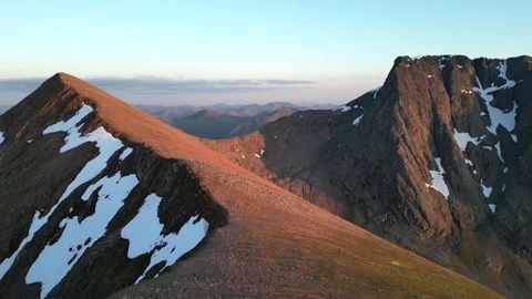 Ben nevis north face and carn mor dearg arete drone aerial with snow and sun Stock Footage 334797080
