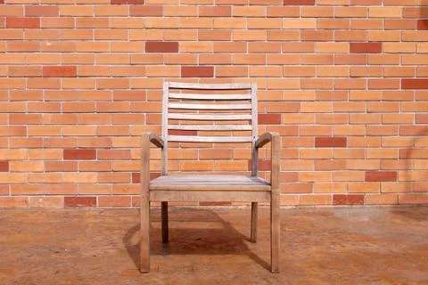 Bench against a brick wall Stock Photos