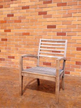 Bench against a brick wall Stock Photos