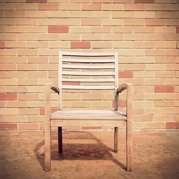 Bench against a brick wall Stock Photos