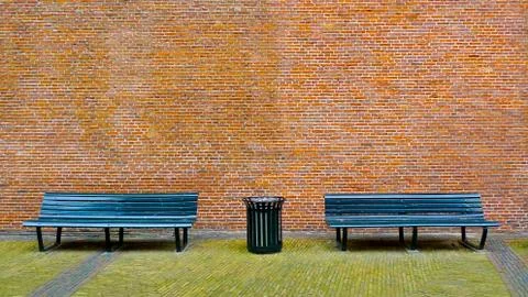 Bench and brick wall Stock Photos