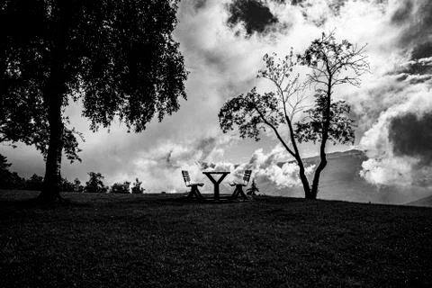 Bench and clouds one Stock Photos
