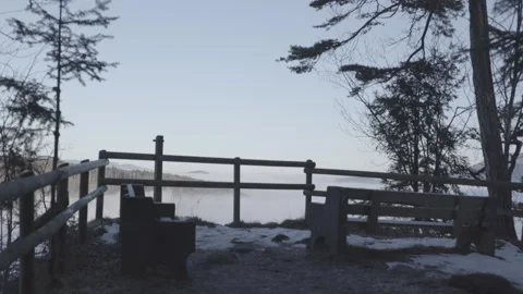Bench and fence on the mountain. View of the fog-shrouded lowland Stock Footage 265073176