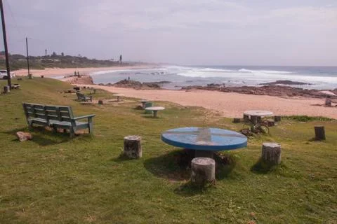 Bench and Picnic Table on Grassed Area at Beach Stock Photos