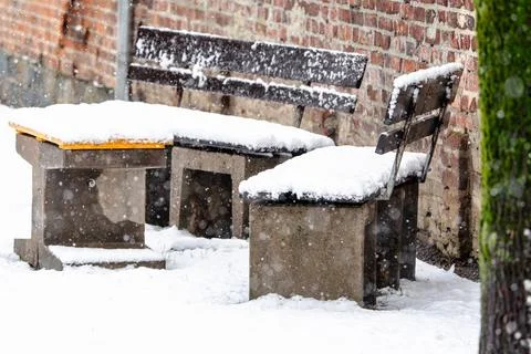 A bench and a table covered in snow Stock Photos