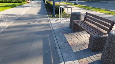 Bench and urn in the park. Empty bench in the alley. Stock Footage 114827618