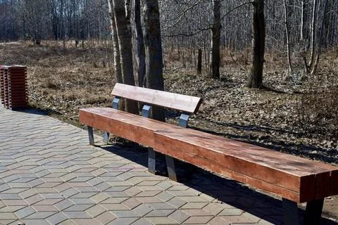 A bench and an urn for separate garbage collection in a city park. Modern des Stock Photos