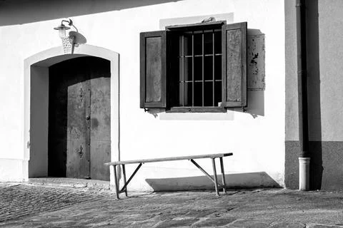 Bench by the barred window Fotos de archivo