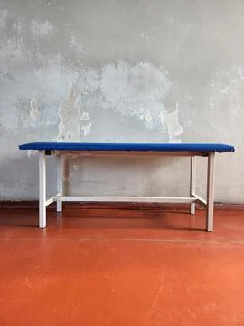 Bench. Bench against the wall. Simple seating furniture Stock Photos