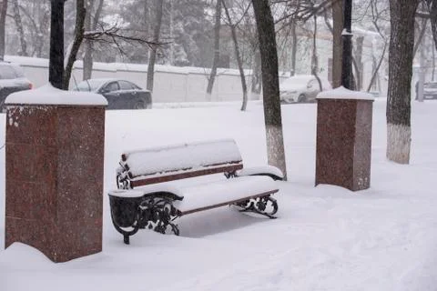 Bench covered with snow Stock Photos