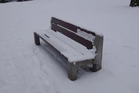 Bench covered in snow Stock Photos