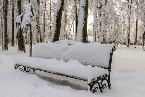 The bench is covered with snow. Stock Photos
