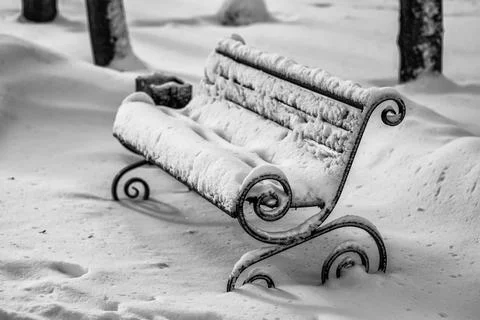 The bench is covered with snow. Stock Photos
