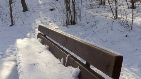 Bench covered with snow in winter Stock Footage 71754467