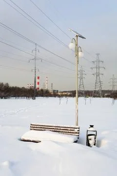 The bench is covered with a thick layer of snow. Stock Photos