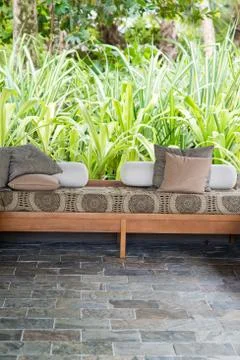 Bench with cushions on outdoor patio Stock Photos