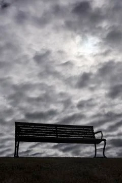 Bench With Dark, Moody Clouds 스톡 사진