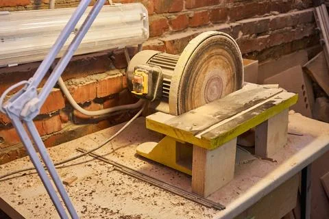 Bench disc sander with lamp in workshop Stock Photos