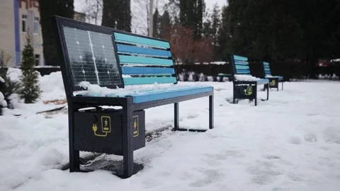 The bench is equipped with a solar panel for electricity energy generation in Stock Footage 258679685