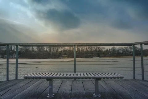 A Bench Facing Out Into The Water Front 스톡 사진