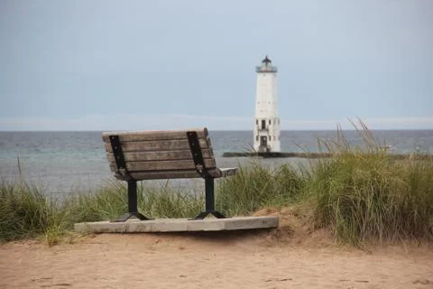 Bench in front of a lighthouse Stock Photos