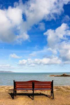 Bench in front of sea Stock Photos
