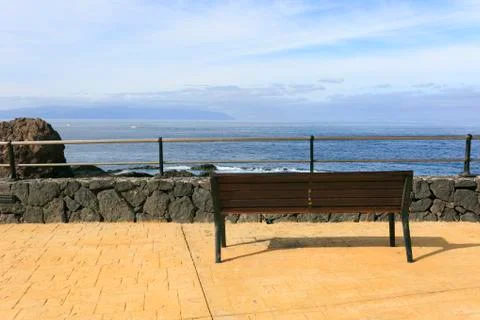 Bench in front of the sea Stock Photos