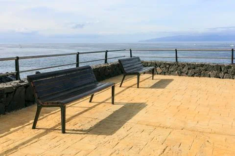 Bench in front of the sea Stock Photos