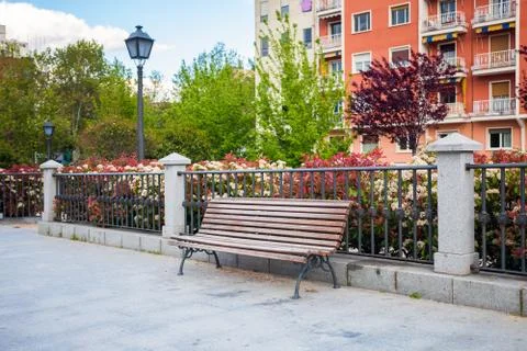 Bench in front of a typical residatial building in Madrid Stock Photos