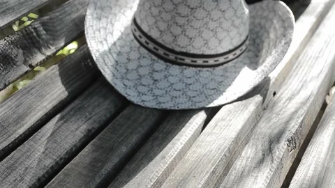 On the bench is a hat Stock Footage 95557943