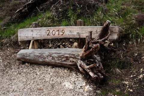 A bench made in 2019 from a fallen tree of Vaia storm that struk italian alps in Stock Photos