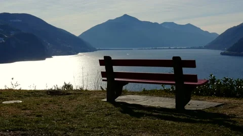 Bench with Mountain View over Lake Lugano in a Sunny Day Stock Footage 191953897
