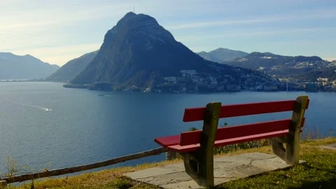 Bench with Mountain View over Lake Lugano in a Sunny Day and Cityscape Stockbeeldmateriaal 191953963