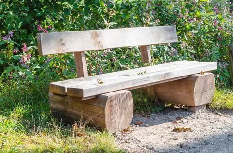 Bench, park bench made ??of tree trunk Bench, park bench made ??of solid t... Stock Photos