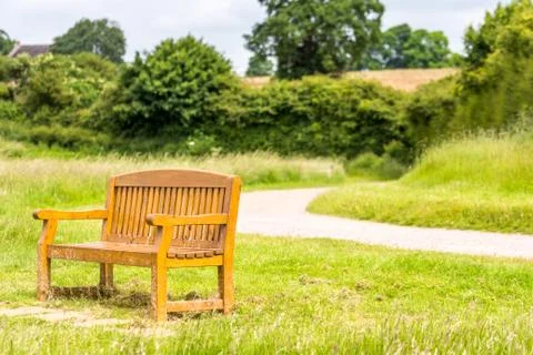 Bench in the park on footpath background Photos