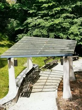 A bench in a park Stock Photos