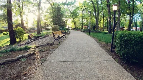 Bench on pathway with sunset Video stock 108586335