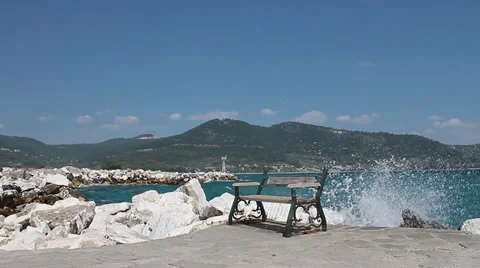 Bench on pier with waves splashing Video stock 30640083