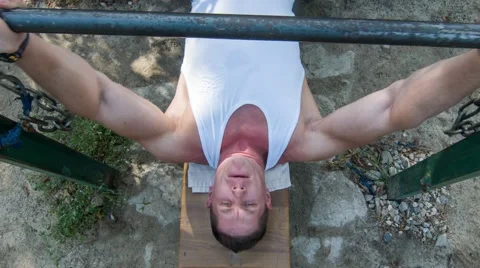 Bench press with makeshift barbell. Outdoor (BMCC 2.5K - 2400x1350) Stock-Footage 47941599